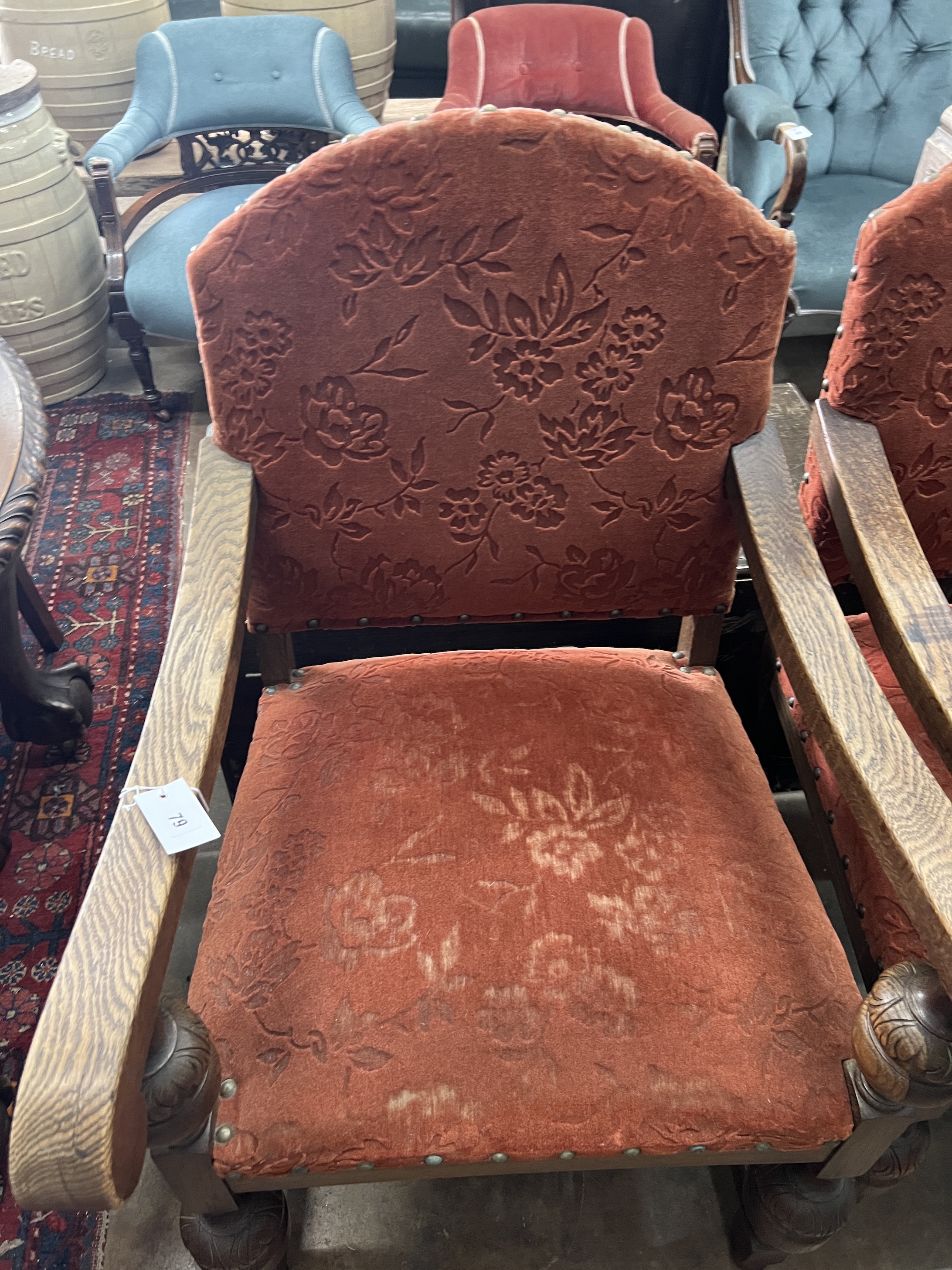 A pair of 1920's Jacobean revival oak elbow chairs, width 60cm, depth 65cm, height 103cm